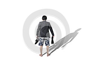 Rear view of businessman trying to make a choice on vacation or