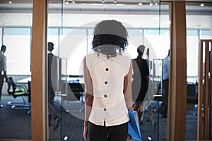 Rear View Of Businesswoman Entering Boardroom For Meeting