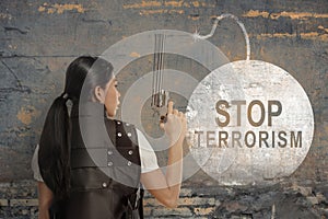 Rear view of a businesswoman holding gun with a stop terrorism sign