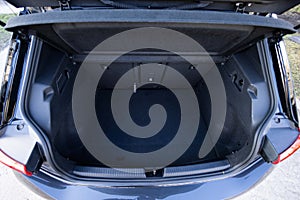 Rear view of the car open trunk. Modern hatchback car with open empty trunk. The car boot is open for luggage. A lot of