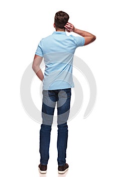Rear view of casual man wearing a blue polo shirt