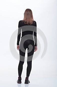 Rear view. casual young woman looking at white wall