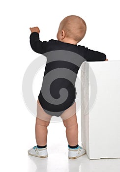 Rear view of caucasian one year infant baby boy toddler kid stan