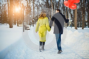 Rear view on cheerful couple having fun outdoors