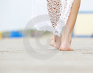 Rear view close up female walking barefoot