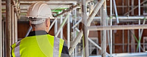 Rear View of a Construction Worker on Building Site photo