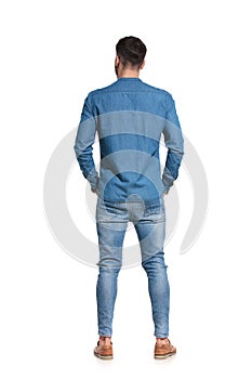 Rear view of a convinced casual man standing