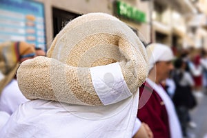 Rear view of a costalero bearers with the Costal Sack Piece of cloth that bearers place on their head and neck in order to photo