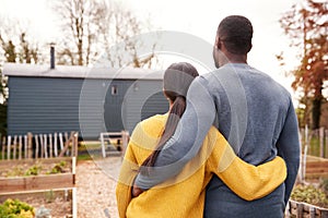 Rear View Of Couple Outdoors Spending Vacation In Eco Lodge