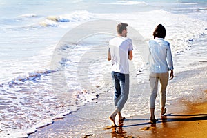 Rear View of Couple Walking at the Beach