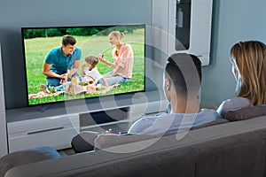 Couple Watching Video On Television photo