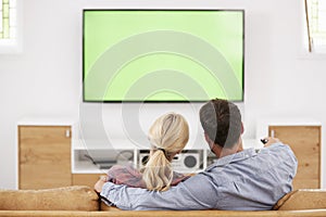 Rear View Of Couple Watching Television Together