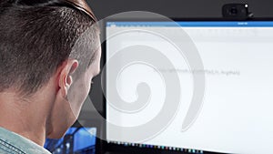 Rear view cropped shot of a computer programmer working late in IT office