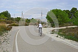 Rear View Of A Cyclist In The Countryside