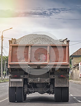 REAR VIEW OF DUMP TRUCK ON THE ROAD