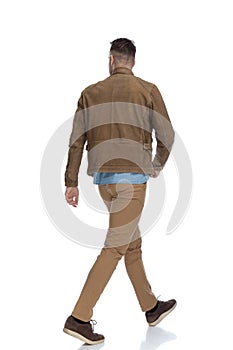 Rear view of a eager casual man walking