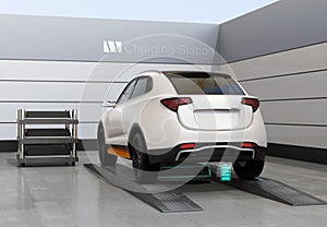 Rear view of electric SUV car exchange battery in battery swapping station