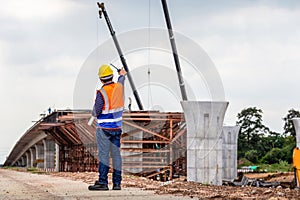 Rear view of Engineer under inspection and checking project at the building site, Foreman worker in hardhat at the infrastructure