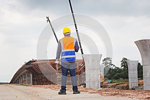 Rear view of Engineer under inspection and checking project at the building site, Foreman worker in hardhat at the infrastructure
