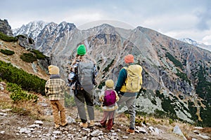 Rear view of family with little children at autumn mountains. Concept of healthy lifestyle.