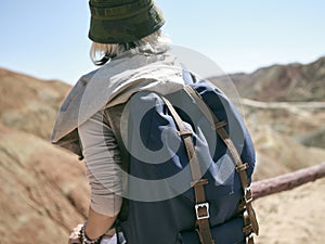 Rear view of female asian tourist backpacker looking at view in national park