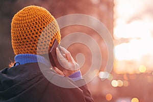 Rear view of female person talking on mobile phone