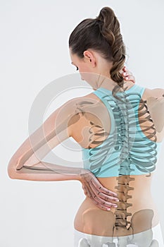 Rear view of female suffering from muscle pain