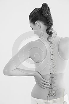 Rear view of female suffering from neck pain