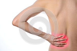 Rear view of a fit topless woman with back pain standing isolate