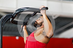 Rear view of fitness model with masculine physique in silhouette.