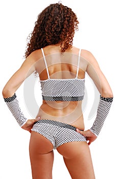 Rear view of frizzy girl in polka dot clothes.