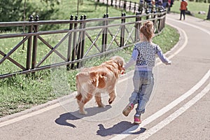 Rear view.girl and her faithful dog for a walk