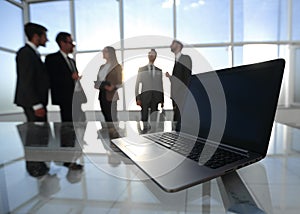 Rear view.a group of business people standing in the lobby of the business center