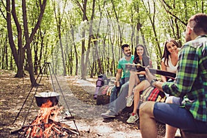 Rear view of a guitarist, fire place, three serene tourists, his