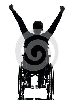 Rear view handicapped man arms raised in wheelchair silhouette