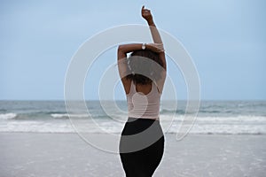 Rear view of happy woman at the beach