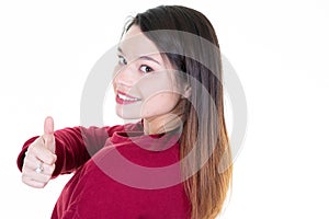 Rear view of a happy woman making thumb up gesture