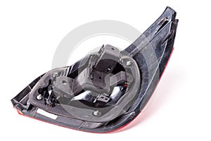 Rear view of the headlights of a brake light of black plastic with mounts on a white isolated background in a photo studio. A