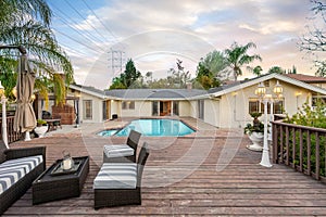 Rear view of a house with a swimming pool and patio in Encino, CA