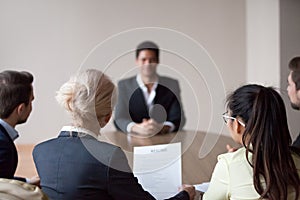 Rear view of hr listening to applicant at job interview photo