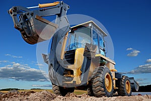 Rear view of Loader excavator with rised backhoe photo