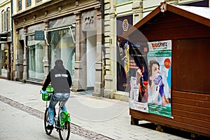 Rear view of lonley man on bike near the testing chalet market stall with