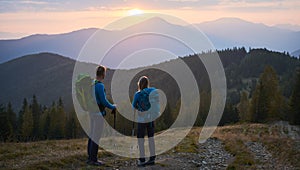 Hiking in the mountains at sunset in summer.