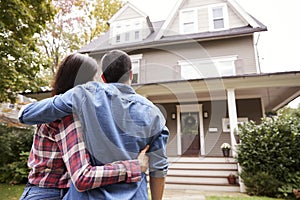 Rear View Of Loving Couple Looking At House