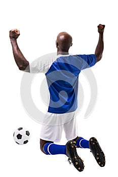 Rear view of male african american player celebrating soccer goal on white background
