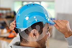 rear view male builder construction worker wearing helmet