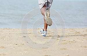 Rear view male jogger at the beach