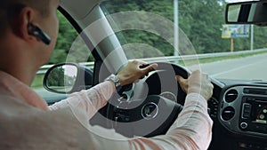 Rear view of man driving car on the highway