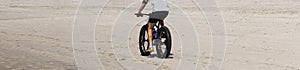 Man riding a fat wheel bike on the beach