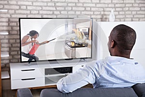 Rear View Of A Man Watching Television